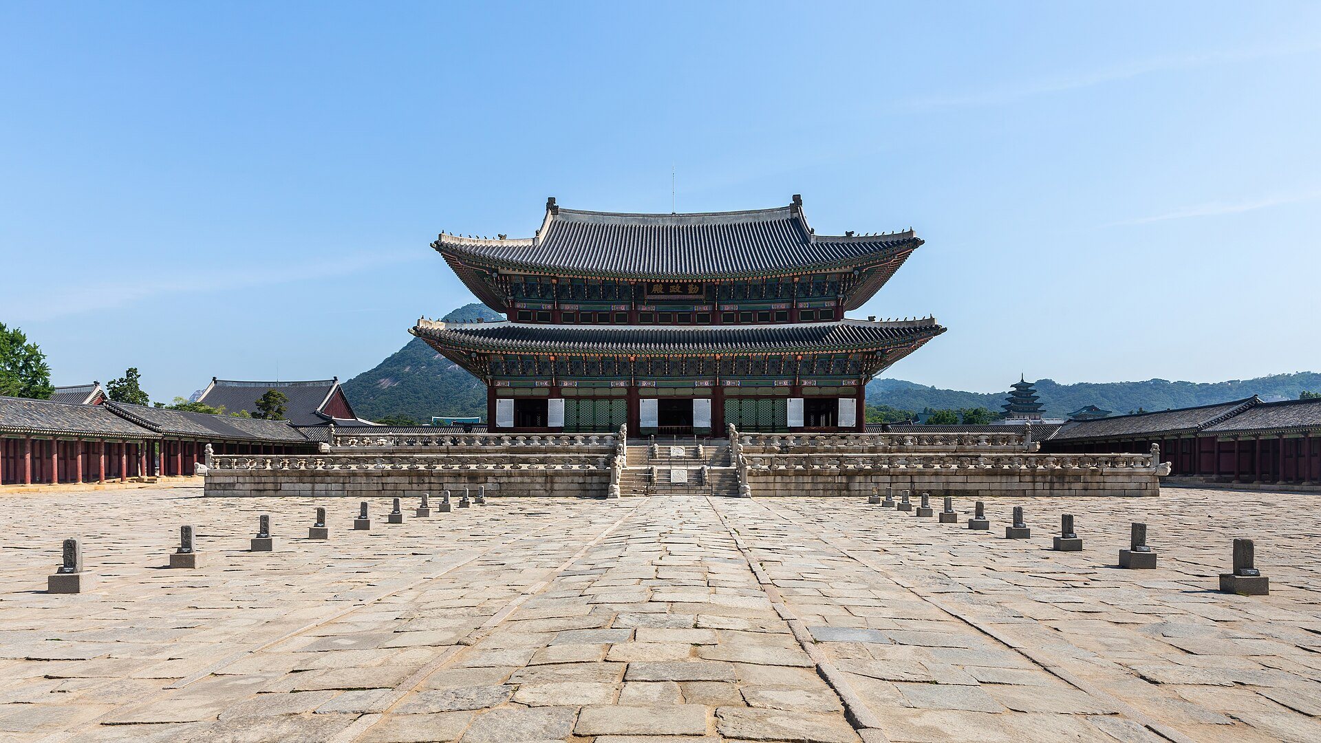 Front view of Geunjeongjeon throne hall at Gyeongbokgung Palace under a blue sky, Seoul